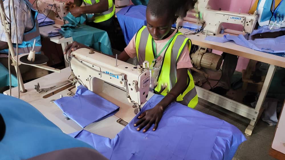Young trainee operating JUKI sewing machine during skills training seminar