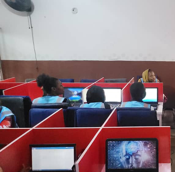Trainees working on laptops in computer training session