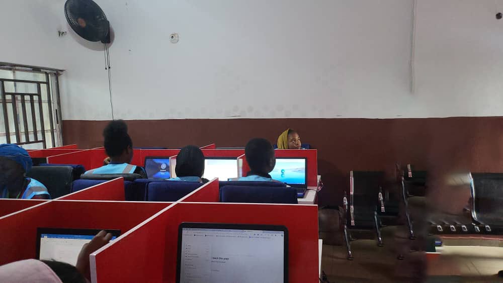 Computer lab session with multiple trainees and instructor supervising